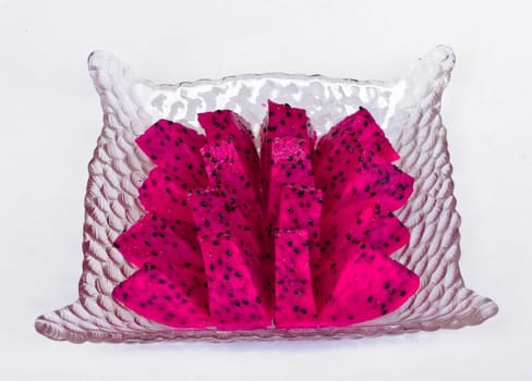 Red dragon fruit cut into pieces in a glass dish