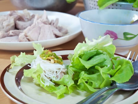 Thai style salad with leaf lettuce, noodle, slice boiling pork and spicy sauce