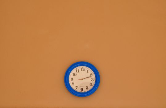 Blue and White Clock on brown Wall