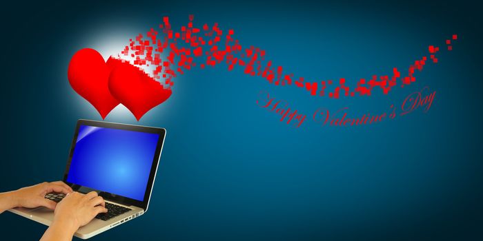Hand of Business Man using laptop to send the Valentine's day greeting