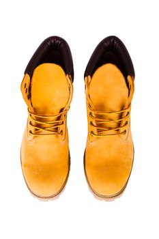 Yellow men's boots isolated on white background