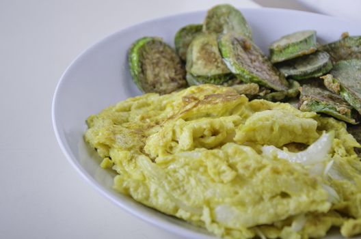 Omelet with fried eggplants vegetables on dish