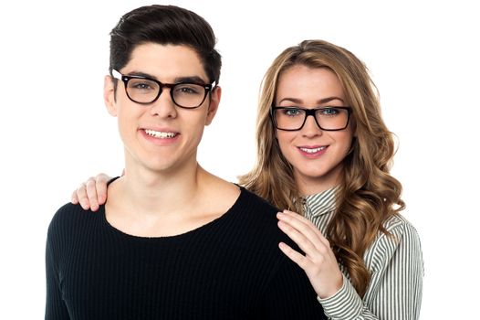 Portrait of a bespectacled young couple posing for a portrait.