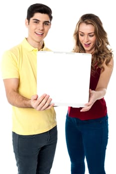 Attractive young woman looking excitedly at the open pizza box.