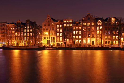 Medieval houses along the Amstel at night in Amsterdam the Netherlands