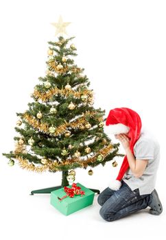 surprised boy in santa hat with christmas present on white background