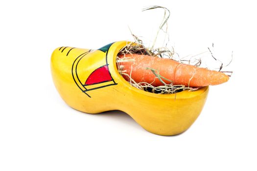Traditional dutch clog with hay and a carrot