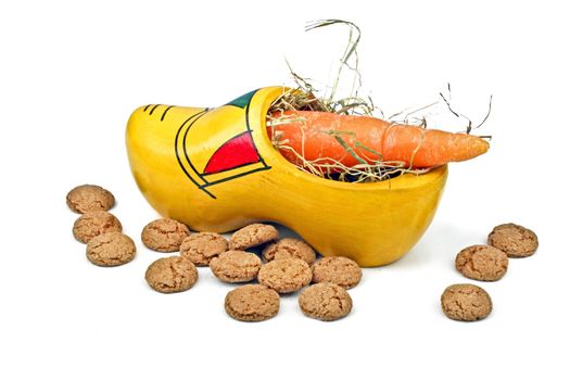 Wooden clog with straw, gingernuts and carrot for 5 december santa claus feast in the Netherlands