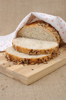 Slices of whole grain bread with cereals on a wooden board