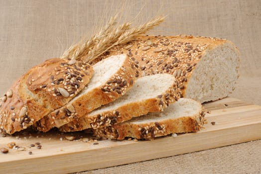 Slices of whole grain bread with cereals on a wooden board