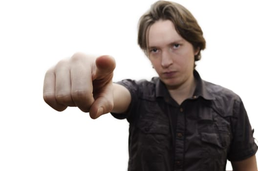 A young man pointing his finger at the viewer. Focus on hand. Isolated on white background.