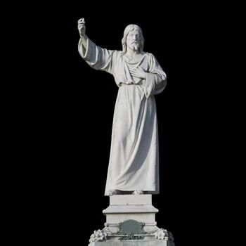A statue of Jesus Christ isolated on a black background. The statue was created in 1904 by the Swiss sculptor Xaver Arnold (1848-1929). It is located in the public cemetery Hamburg Ohlsdorf.