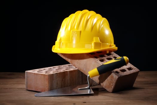 Bricks, trowel and helmet on work place