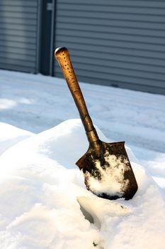 little shovel burried in heavy snow 