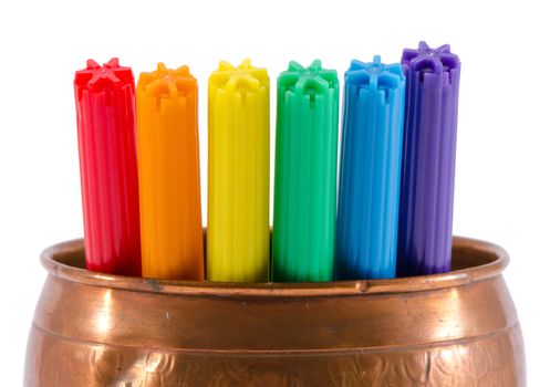 closeup of gay color felt-tip pens in copper bowl isolated on white background