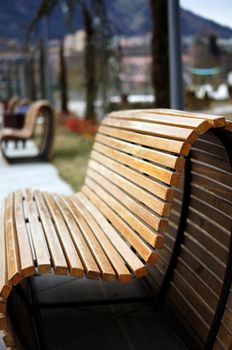 Wooden park bench in a sunny day - winter time