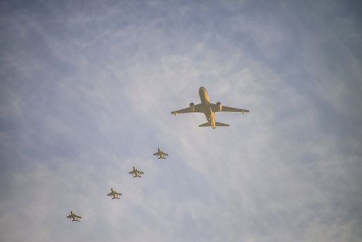 the image is shot over the airspace in sharm el sheikh, egypt and shows a large military aircraft escorted by four jet fighters, january 2013.