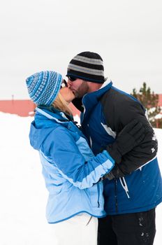 Beautiful Couple kissing in the snow in Colorado