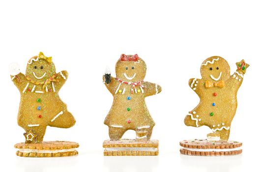 Three glittery holiday gingerbread cookies isolated on white background.