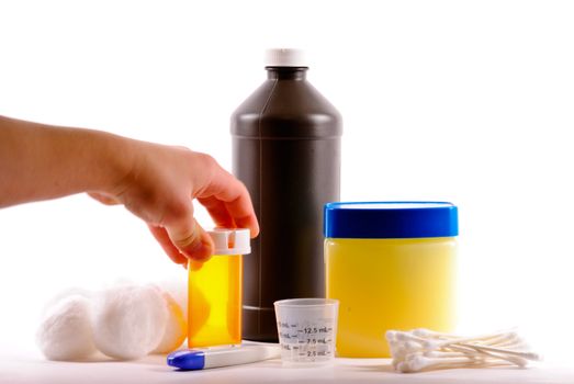 Child hand reaching for prescription medicine on white background.