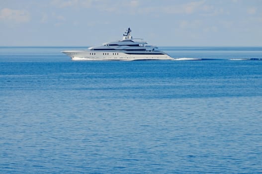 A large private motor yacht under way out at sea, copy space