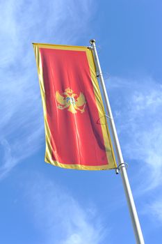 Montenegro waving flag against blue sky