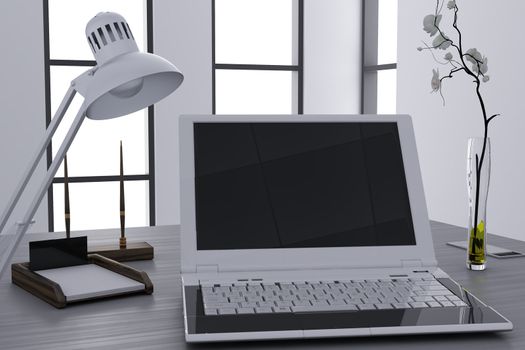 laptop and flower in vase on table in modern cubicle