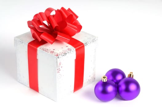 New year gift box isolated on white with Christmas balls, red and purple