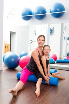 Aerobics woman personal trainer of children girl stability with foam roller