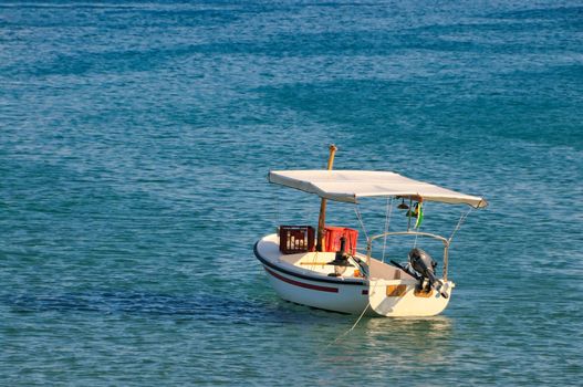 Fishing boat anchored on a turquoise sea