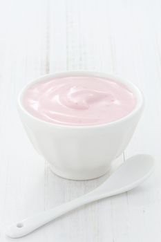 Fresh, healthy and delicious creamy, strawberry yogurt in vintage French cup, the perfect snack or dessert.