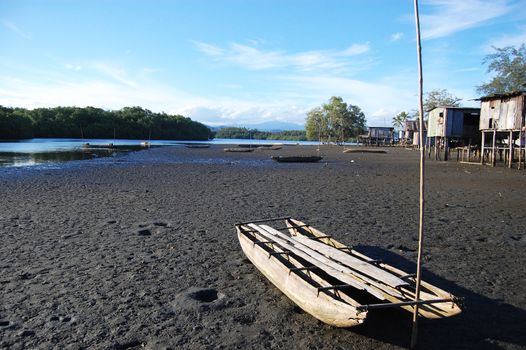 Canoe at village river coast, Papua New Guinea