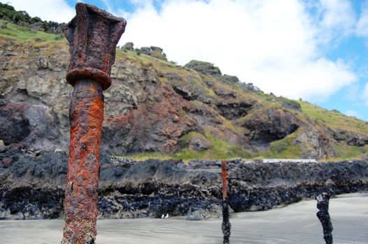 Old rusty metal parts on beach, Banks Peninsula, New Zealand