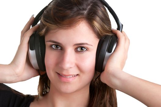 Young woman listening to music through her headphones, isolated in a whiite background