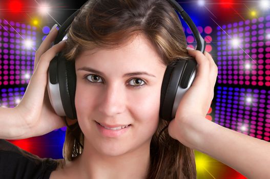 Young woman listening to music through her headphones, isolated in a whiite background