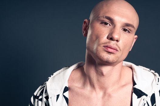 Studio portrait of shirtless muscled bald man