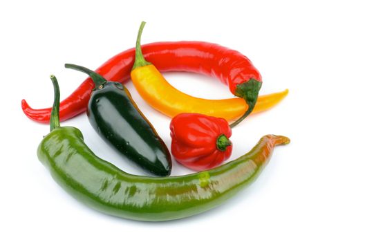 Arrangement of Various Chili Peppers with Red Habanero, Green Jalapeño, Yellow Santa Fee, Green and Red Peppers isolated on white background