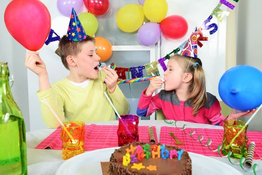 Happy little children are having fun in a birthday party 