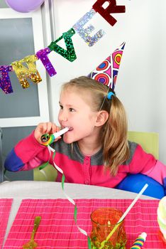 Happy little girl how have fun in a birthday party 