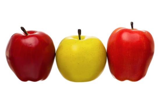 Artificial red, orange and green apples, isolated on white background