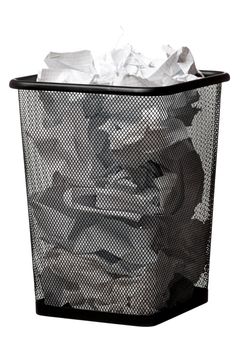 Black garbage bin with paper waste, isolated on white background