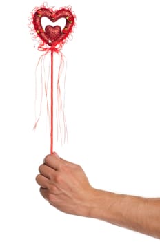 Man hand with heart on a stick with red ribbon isolated on white background