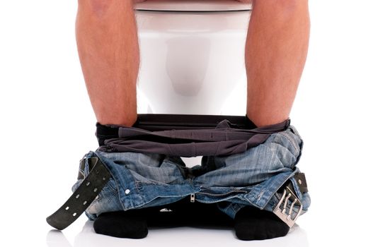 Man is sitting on the toilet bowl, on white background