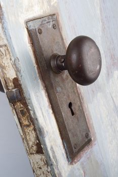 A vintage and worn door, handle and keyhole 
