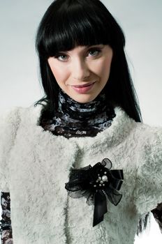 Portrait of beautiful sexy brunette girl with black brooch