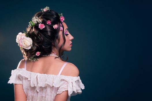 Young girl with creative hairstyle with flowers