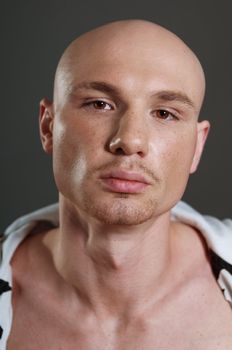 Studio portrait of shirtless muscled bald man