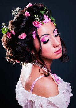 Young girl with creative hairstyle with flowers