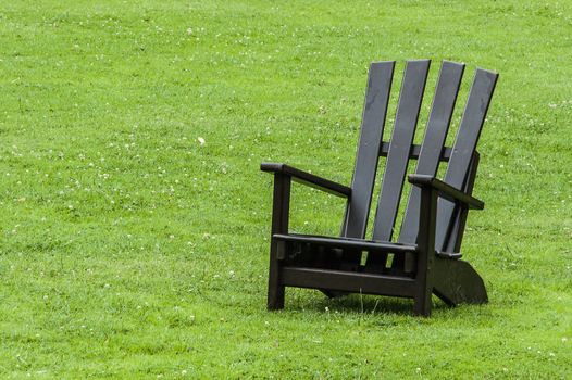 Classical wooden armchair in a park