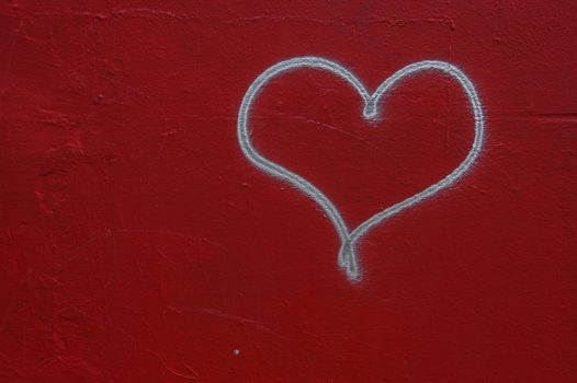 Heart graffiti on a red wall